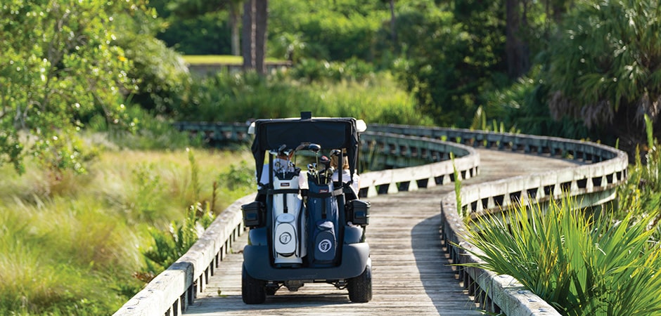 golf cart riding on dedicated path in tesoro club